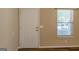 Bright entryway with a door, window, and light neutral walls and flooring at 2375 Lexington Ln, Cumming, GA 30040