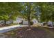 Exterior shot of a single Gathering home with a well-maintained lawn and mature shade trees at 2375 Lexington Ln, Cumming, GA 30040