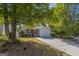 View of a single-Gathering home with a driveway and a manicured front lawn with mature trees at 2375 Lexington Ln, Cumming, GA 30040