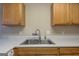 Kitchen showcasing stainless steel sink with white countertops and wood cabinets at 2375 Lexington Ln, Cumming, GA 30040