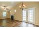Living room has a fireplace, vaulted ceiling, wood-look floors and sliding glass doors at 2375 Lexington Ln, Cumming, GA 30040