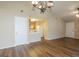 Open-concept space features wood-look flooring, a ceiling fan, and a view into the kitchen at 2375 Lexington Ln, Cumming, GA 30040