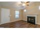 Living room with a fireplace, wood-look flooring, a ceiling fan, and a window at 2375 Lexington Ln, Cumming, GA 30040