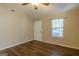 Bright living room features a ceiling fan, wood-look flooring, and a window with wood blinds at 2375 Lexington Ln, Cumming, GA 30040