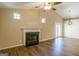 Living room with a fireplace, wood-look floors, vaulted ceiling and view to additional room at 2375 Lexington Ln, Cumming, GA 30040