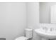 Bright bathroom featuring a toilet and a sink at 121 Chattahoochee Circle, Locust Grove, GA 30248