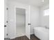 Bathroom featuring a modern bathtub with a chrome faucet and access to the bedroom at 121 Chattahoochee Circle, Locust Grove, GA 30248