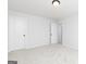 Empty bedroom with two doors and carpeted floors in a modern designed home at 121 Chattahoochee Circle, Locust Grove, GA 30248