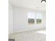 Light-filled bedroom with plush carpeting and scenic outdoor views from the windows at 121 Chattahoochee Circle, Locust Grove, GA 30248