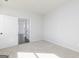 Inviting bedroom with plush carpet and an open doorway to another room at 121 Chattahoochee Circle, Locust Grove, GA 30248