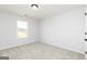 Clean bedroom with carpeted floors and a window overlooking the neighborhood at 121 Chattahoochee Circle, Locust Grove, GA 30248