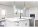 Open kitchen with island, sink, stainless steel appliances, and an adjacent living area at 121 Chattahoochee Circle, Locust Grove, GA 30248