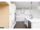 Modern kitchen with white cabinets, stainless steel appliances, and dark wood flooring at 121 Chattahoochee Circle, Locust Grove, GA 30248