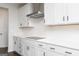Modern kitchen features white cabinets, subway tile, and stainless steel appliances at 121 Chattahoochee Circle, Locust Grove, GA 30248