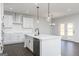 Bright, open kitchen featuring a large island with seating and modern pendant lighting at 121 Chattahoochee Circle, Locust Grove, GA 30248