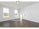 Sunlit living room with hardwood floors, large windows, and a door to the backyard at 121 Chattahoochee Circle, Locust Grove, GA 30248