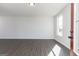 Open-concept room with hardwood floors, neutral walls, and a door to the outside at 121 Chattahoochee Circle, Locust Grove, GA 30248