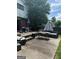 Backyard with outdoor furniture, patio, barbecue grills, and a privacy fence with a wooded tree line at 268 Rountree Rd, Riverdale, GA 30274