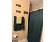Standard bathroom featuring a green shower curtain, towel rack, and necessary fixtures at 268 Rountree Rd, Riverdale, GA 30274