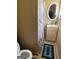 Cozy bathroom featuring a toilet, vanity with a sink, and a floral shower curtain for added privacy at 268 Rountree Rd, Riverdale, GA 30274