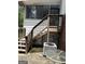 Exterior of the home featuring an outdoor staircase leading to a second level entrance and central air conditioning unit at 268 Rountree Rd, Riverdale, GA 30274