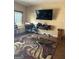 The living room features hard wood floors, an area rug, an entertainment center, and natural lighting at 268 Rountree Rd, Riverdale, GA 30274