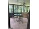 The patio features a glass top table with 4 chairs, screening, and natural lighting at 268 Rountree Rd, Riverdale, GA 30274
