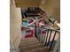 View of the home's stairway with carpeted steps and black iron railing and a colorful area rug at the bottom of the stairs at 268 Rountree Rd, Riverdale, GA 30274