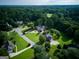Aerial view of homes with manicured lawns and mature trees in a residential neighborhood at 165 Mcelwaney Way, Fayetteville, GA 30215