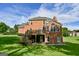 Brick home featuring a large deck and a spacious green backyard at 165 Mcelwaney Way, Fayetteville, GA 30215