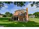 Brick home featuring a large deck and a lush green backyard at 165 Mcelwaney Way, Fayetteville, GA 30215