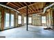 Unfinished basement with windows, double door, open ceiling, and concrete floor at 165 Mcelwaney Way, Fayetteville, GA 30215