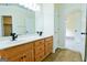 Bathroom features double sink vanity, a large mirror, and an open doorway to the bedroom at 165 Mcelwaney Way, Fayetteville, GA 30215