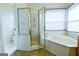 Bathroom featuring corner tub, glass shower, tile floors, and a toilet at 165 Mcelwaney Way, Fayetteville, GA 30215
