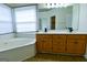 Bathroom features a corner tub with jets, a large mirror, and a double sink vanity at 165 Mcelwaney Way, Fayetteville, GA 30215