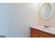Bathroom featuring a wooden vanity, granite countertop, and oval mirror at 165 Mcelwaney Way, Fayetteville, GA 30215