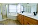 Bathroom features a large tub, glass shower, and double sink vanity with wood cabinets at 165 Mcelwaney Way, Fayetteville, GA 30215