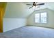 This bedroom features neutral walls and carpet, and large windows at 165 Mcelwaney Way, Fayetteville, GA 30215