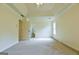 Bedroom with neutral carpet features a tray ceiling and an open doorway to a bathroom at 165 Mcelwaney Way, Fayetteville, GA 30215