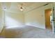 Spacious bedroom features a tray ceiling, ceiling fan, and neutral carpet at 165 Mcelwaney Way, Fayetteville, GA 30215