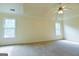Spacious bedroom with tray ceiling and fan features large windows and neutral carpet at 165 Mcelwaney Way, Fayetteville, GA 30215