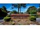Brick community sign with 'Rebecca Lakes' in gold lettering with landscaping at 165 Mcelwaney Way, Fayetteville, GA 30215