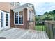 Exterior brick elevation viewed from the wood plank deck and railing at 165 Mcelwaney Way, Fayetteville, GA 30215