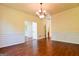 Spacious dining room featuring hardwood floors, wainscoting, and chandelier at 165 Mcelwaney Way, Fayetteville, GA 30215