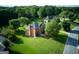 Aerial view of a brick two-story home on a large lot with mature trees at 165 Mcelwaney Way, Fayetteville, GA 30215