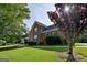 Traditional two-story brick home featuring a well-maintained lawn and mature landscaping at 165 Mcelwaney Way, Fayetteville, GA 30215