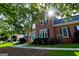 Brick home with a manicured lawn and a bright sunlit view of the front entrance at 165 Mcelwaney Way, Fayetteville, GA 30215