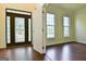 Inviting foyer with hardwood floors, a decorative glass door, and natural light at 165 Mcelwaney Way, Fayetteville, GA 30215