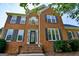 Traditional brick home with black shutters and an arched window above the front door at 165 Mcelwaney Way, Fayetteville, GA 30215