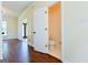 Hallway with hardwood floors leading to bathroom and view of front door at 165 Mcelwaney Way, Fayetteville, GA 30215